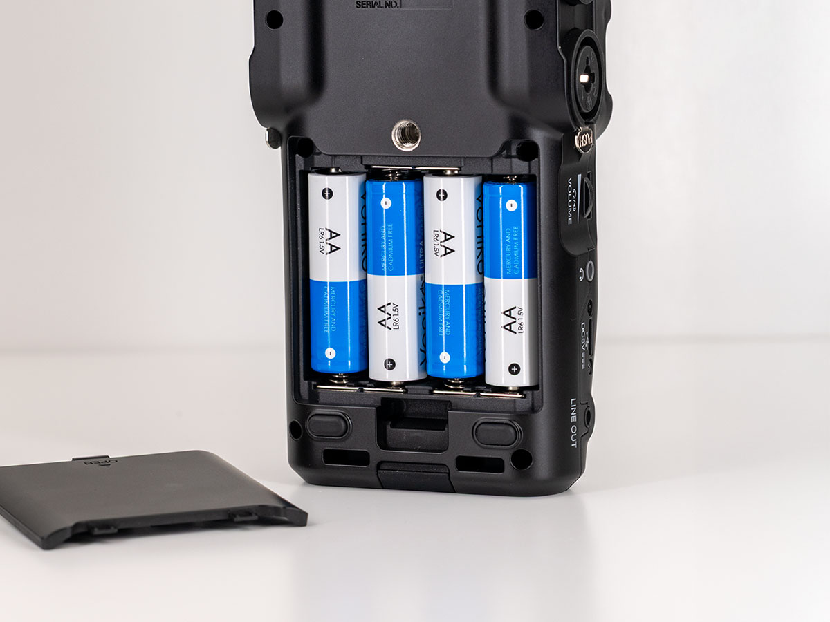 Geöffnetes Batteriefach des Zoom H6studio mit vier AA-Batterien